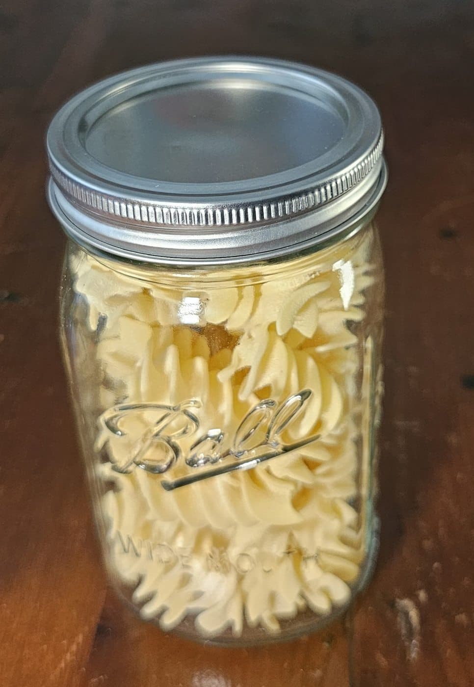 Dry pasta stored in a vacuum-sealed wide-mouth Mason jar
